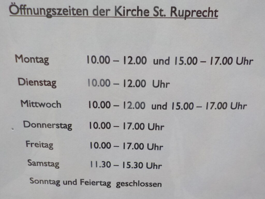 This photo shows a church's opening hours. It is open Monday through Saturday but closed Sundays and holidays.