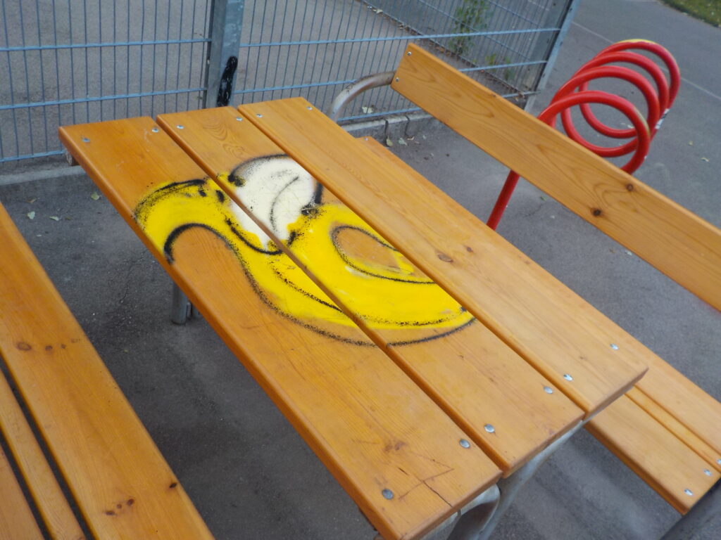 This photo shows a spray-painted banana on a wooden table in a park in Vienna.