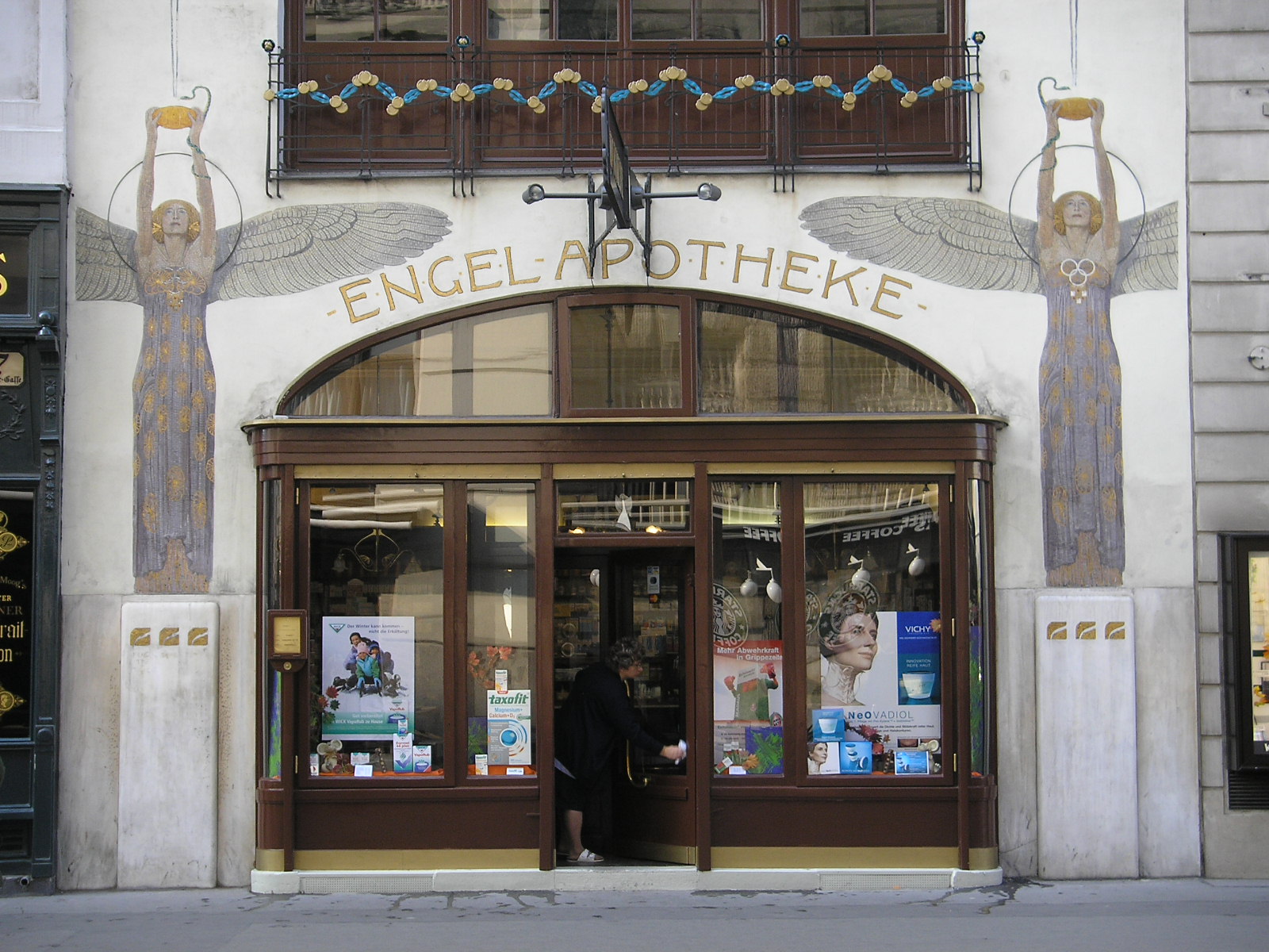 Storefront for Engel Apotheke that depicts an angel on either side of the door