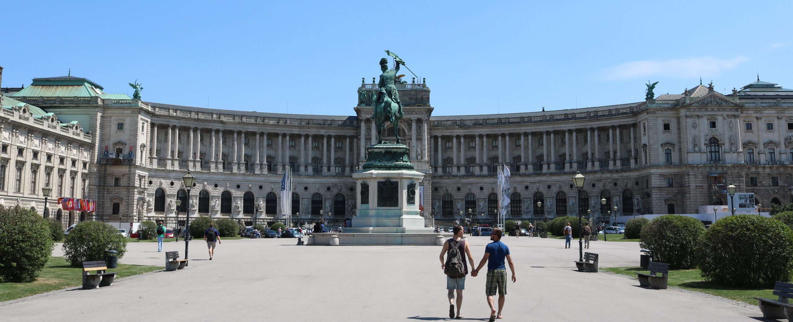 image of two men holding hands on Heldenplatz in Vienna