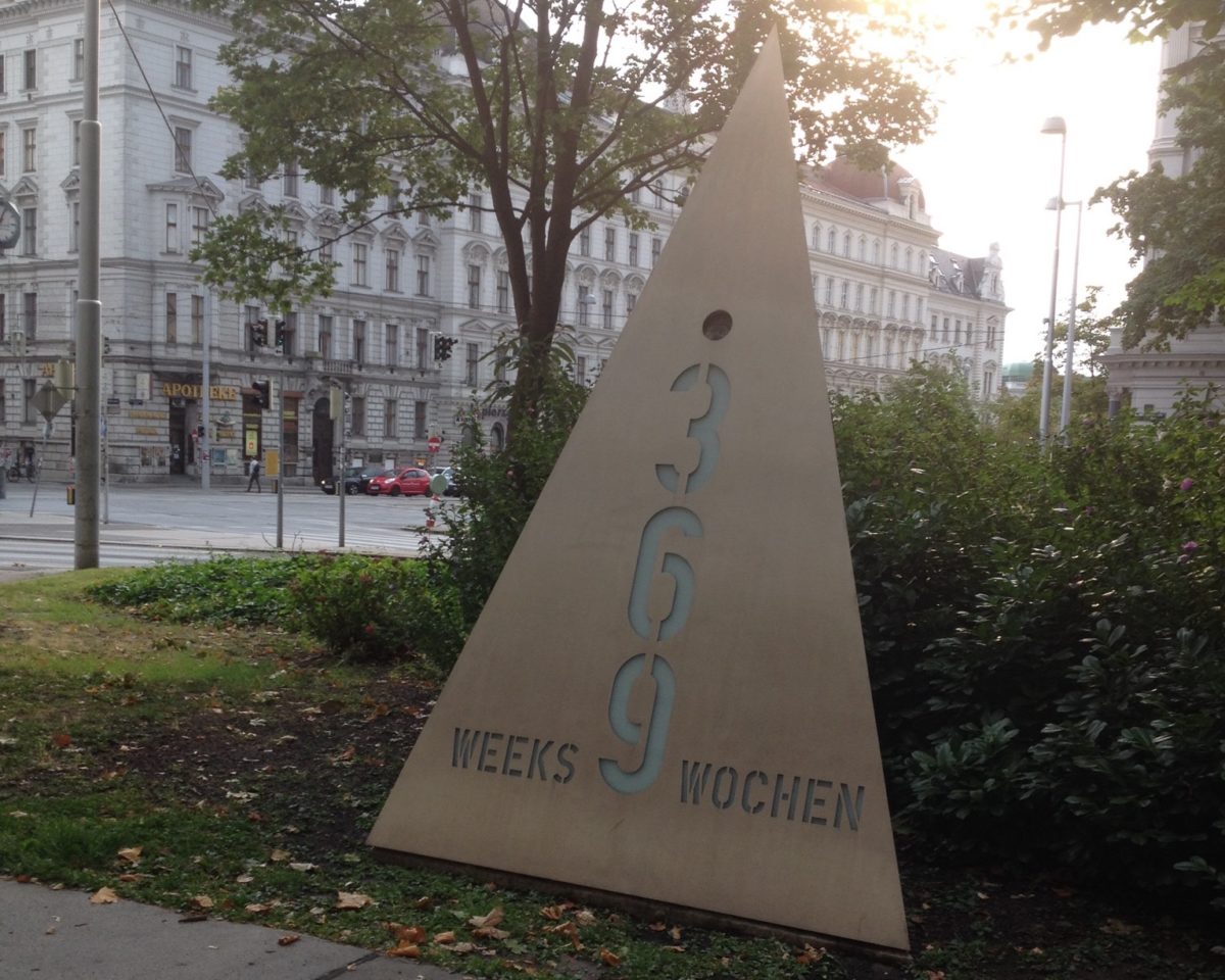 Triangular metal memorial that reads 369 weeks and wochen