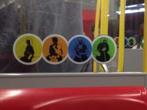Sticker on window depicting who should receive priority seating on public transit