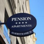 Outdoor sign that reads Pension apartments