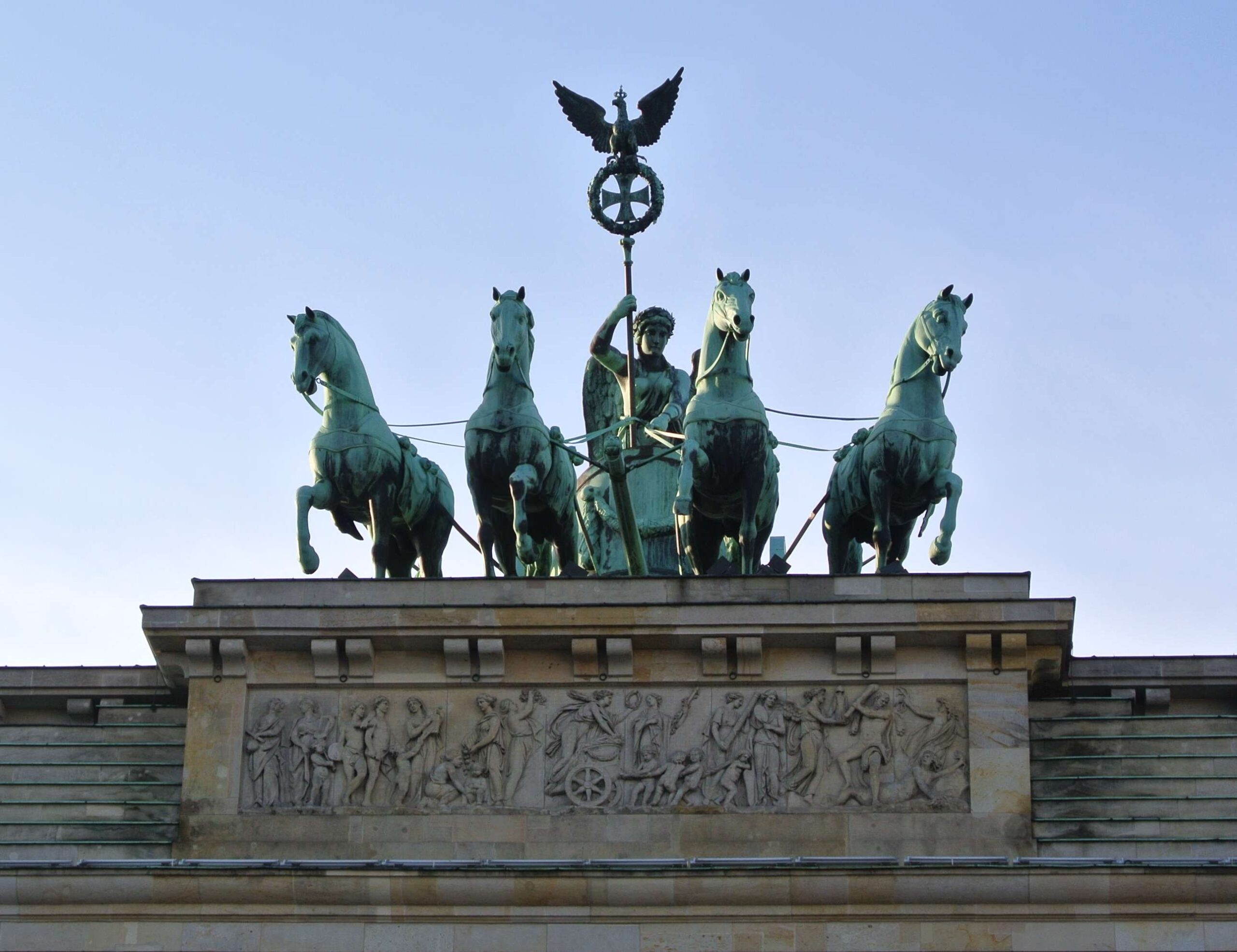 Brandenburger Tor a monument that depicts a woman leading a chariot drawn by four horses