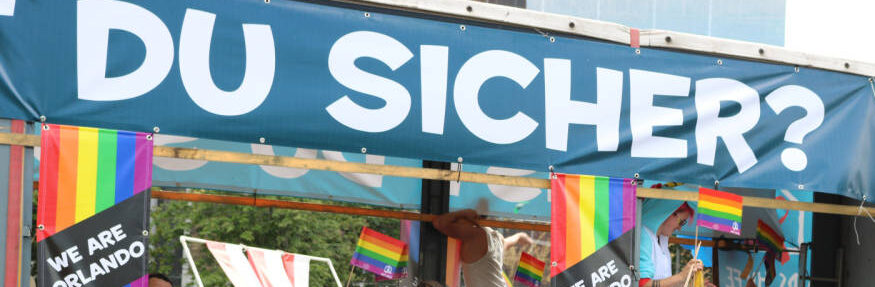 People on parade float that reads Bist Du Sicher?