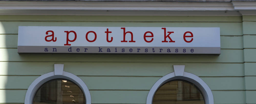 green building with an apotheke sign on it